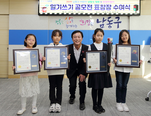 ▲ ‘안전지킴이 일기쓰기 공모전’ 표창 수여자와 기념촬영하는 이강호 남동구청장(가운데).