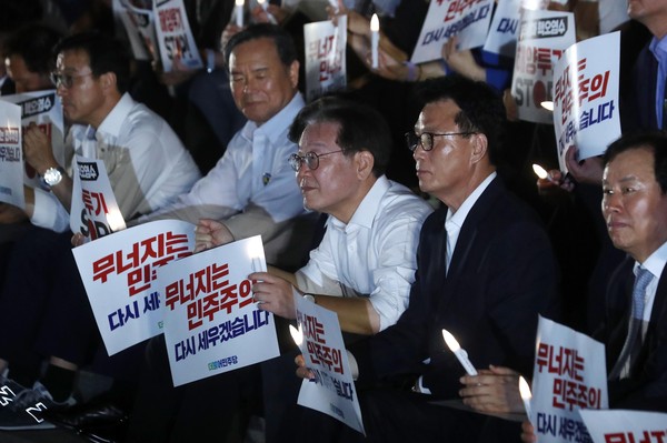 ▲ 4일 오후 서울 여의도 국회 본청 앞 계단에서 열린 제2차 윤석열 정권 폭정 저지 민주주의 회복 촛불문화제에서 이재명 더불어민주당 대표가 손피켓과 촛불을 들고 있다. /뉴시스