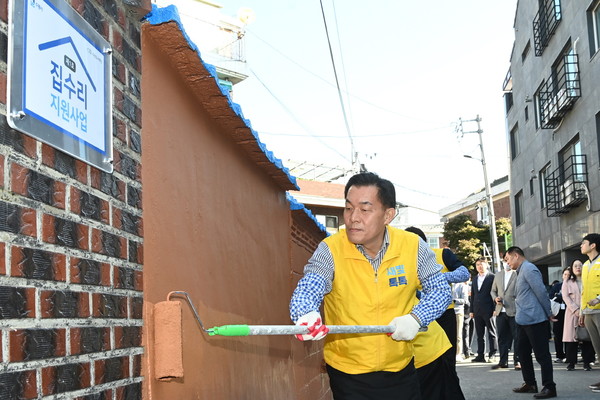 ▲ 이재준 수원특례시장이 지난해 10월 수원형 저층주거지 집수리 지원사업 1호 기념식에서 페인트를 칠하고 있다.