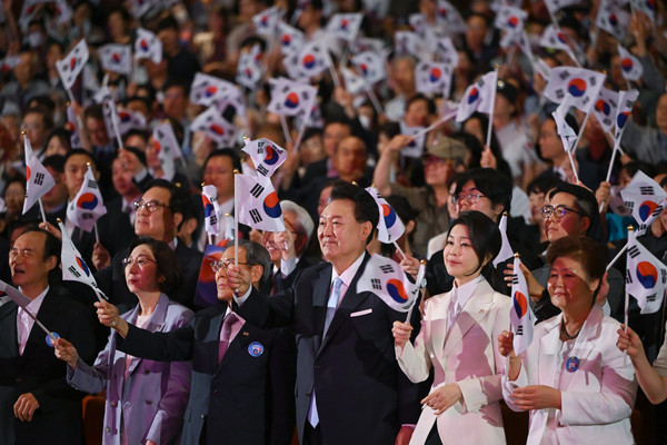 ▲ 윤석열 대통령과 부인 김건희 여사가 지난 15일 서울 종로구 세종문화회관에서 열린 제79주년 광복절 경축식에서 광복절의 노래에 맞춰 태극기를 흔들고 있다. /뉴시스
