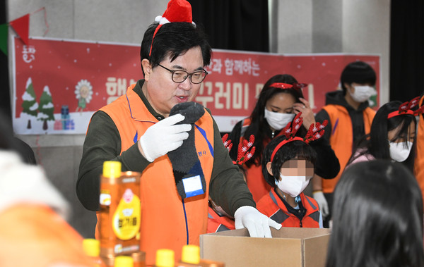 ▲ 박일하 동작구청장이 작년 행복나눔 꾸러미 봉사활동에 참여해 자원봉사자들과 물품을 담고 있다.