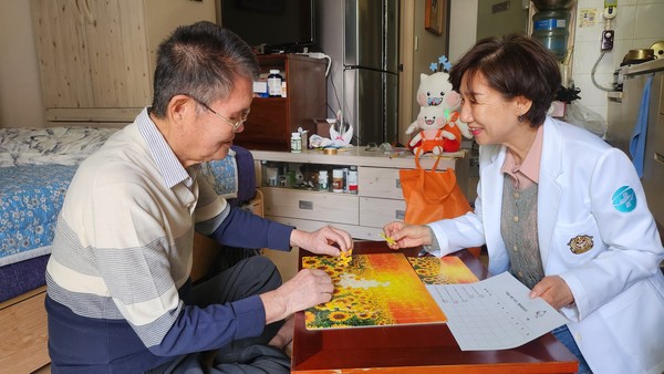 ▲ 하남시 방문간호사가 독거 어르신과 함께 꽃그림 퍼즐을 맞추며 따뜻한 시간을 보내고 있다.